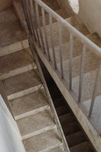 Kaboompics - Concrete Stairwell with White Metal Handrail and Geometric Lines