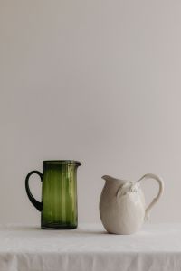 Kaboompics - Paired Green Glass and White Ceramic Pitchers with Copy Space