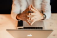 Kaboompics - Close-Up of Designer's Steepled Hands Above a Laptop