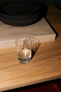 Kaboompics - Glass Of Water On Wooden Coffee Table With Dramatic Light