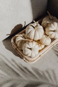 Kaboompics - Wicker Tray of White Pumpkins on Beige Fabric