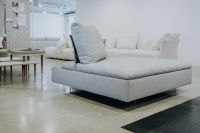 Kaboompics - Light Gray Upholstered Ottoman in Front of a White Modular Sofa Display