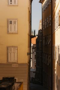 Kaboompics - Old Stone Alley with Wall Lanterns and Shuttered Windows