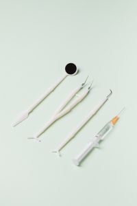 Kaboompics - Dental Tools and Syringe Arranged on Pale Mint