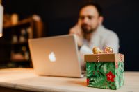 Kaboompics - Christmas Gift Box on Desk with Designer and Laptop in Background