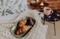 Kaboompics - Croissants and Fresh Figs on a Green Ceramic Plate, Cozy Bedside Coffee and Candle Still Life