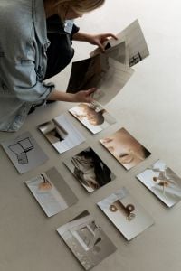 Kaboompics - Designer Arranging Printed Moodboard Images and Material Samples on a Neutral Floor