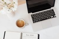 Kaboompics - Overhead Work from Home Setup with Laptop, Coffee and Monthly Planner
