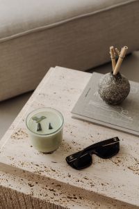 Kaboompics - Travertine Coffee Table with Green Drink, Sunglasses and Art Book