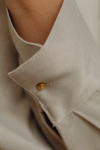 Kaboompics - Gold Button on Tan Silk Shirt Cuff