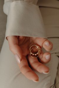 Kaboompics - Woman Holding Two Gold Rings in Her Hand