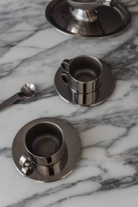 Kaboompics - Three Chrome Espresso Cups on Arabescato Marble