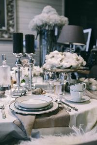 Fancy restaurant dinner table decorated with quail eggs and feathers