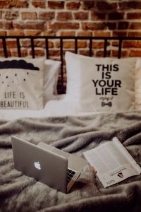 Enjoying evening with a Macbook in a nice bed