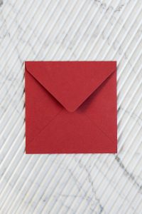 Kaboompics - Large Red Envelope on Ribbed Marble, Vertical Minimal Stationery Mockup