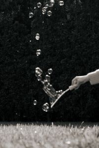 Kaboompics - Black and White Hand Holding a Multi-Loop Bubble Wand