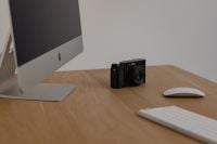 Kaboompics - Fujifilm X100VI Camera Beside Desktop Computer