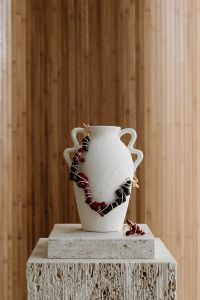Kaboompics - Red and Black Beaded Necklace on a Ceramic Vase