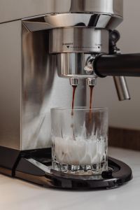 Kaboompics - Espresso Pouring into Milk in a Faceted Glass