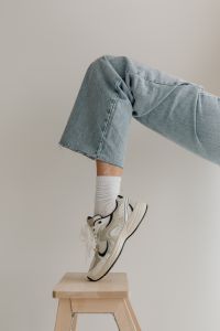 Kaboompics - Bent Knee in Light Blue Wide-Leg Denim against a Clean Neutral Studio Background