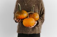 Kaboompics - Woman Holding Three Autumn Pumpkins