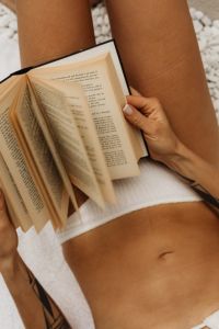 Kaboompics - Page-Turning Close-Up of a Woman Reading in a White Bikini