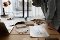 Kaboompics - Interior Design Worktable with Material Swatches, Architectural Prints and Laptop