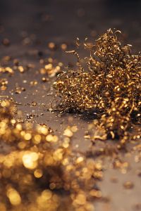 Close-ups of golden metal shavings on a table