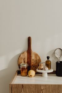 Kaboompics - Vertical Kitchen Background with Amber Pantry Jar, Lemon and Wooden Cutting Boards, Copy Space