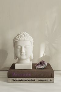 Kaboompics - White Buddha Bust On Books With Amethyst Crystal