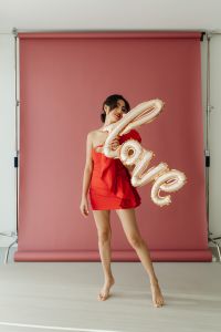 Valentine’s Day Fashion Editorial With Heart Balloons, Roses and Gifts