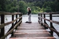Kaboompics - Blonde woman having a healthy snack at the wooden pier