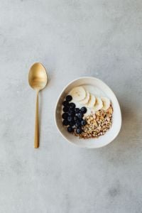 Kaboompics - Blueberry Yogurt Breakfast Bowl with Banana, Granola and Spoon