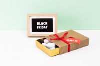 Kaboompics - Black Friday Sign and Open Gift Box with Sale Tag on Mint Background