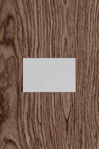 Kaboompics - Blank Business Card on Dark Wood Grain, Minimal Vertical Branding Mockup Background