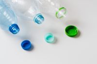 Kaboompics - Open Plastic Bottles and Colorful Caps on White