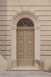 Kaboompics - Ornate Maltese Door with Arched Fanlight and Limestone Facade