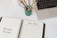 Kaboompics - Neutral Work from Home Desk with Laptop and Open Weekly Planner