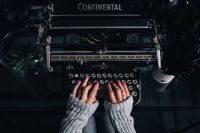 Kaboompics - Woman typing on an old typewriter