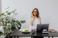 Kaboompics - Woman in Glasses Taking a Business Call at Office Desk