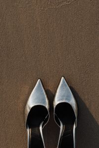 Kaboompics - Close-Up Silver Heels on Dark Wet Beach Sand