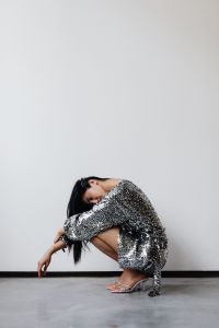 Kaboompics - Asian Woman Wearing a Silver Sequin Dress on a White Background