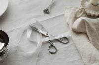 Kaboompics - Close Up White Plate with Spoon and Crystal Glass on Linen Tablecloth