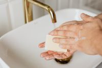 Kaboompics - Rubbing a Bar of Soap between Hands at a White Sink, Handwashing Education Photo