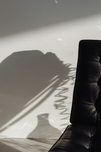 Kaboompics - Lounge Chair Shadow and Silver Party Streamers on a White Wall