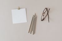 Kaboompics - Blank Card, White Pencils and Tortoiseshell Glasses on a Neutral Desktop