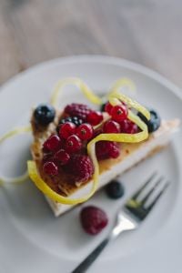 Kaboompics - Berry Cheesecake Slice with Fork and Fresh Berries