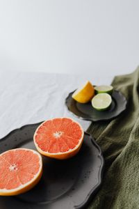 Kaboompics - Vertical Grapefruit and Citrus Plates with White Copy Space, Healthy Food Campaign