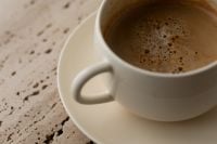 Kaboompics - Close Up of Foamy Coffee in Cream Ceramic Cup