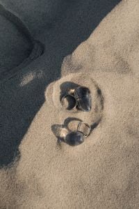 Kaboompics - Silver Rings on Sunlit Sand with Long Natural Shadows
